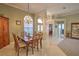 Dining room featuring classic decor, chandelier, and a view of the foyer, blending traditional style with modern lighting at 4532 Saddleworth Cir, Orlando, FL 32826