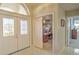 Welcoming foyer with tile flooring, glass panel door and natural light, leading to an office and other living spaces at 4532 Saddleworth Cir, Orlando, FL 32826