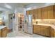 Well-organized pantry with shelves, stainless steel refrigerator, and wooden cabinets in this kitchen at 4532 Saddleworth Cir, Orlando, FL 32826