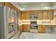 Well-lit kitchen with stainless steel appliances, wooden cabinets, and lots of counter space at 4532 Saddleworth Cir, Orlando, FL 32826