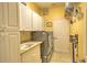 Well-equipped laundry room with cabinets and sink at 4532 Saddleworth Cir, Orlando, FL 32826