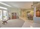 Spacious living room with carpeted floors, natural light and traditional decor flowing into an adjacent dining area at 4532 Saddleworth Cir, Orlando, FL 32826