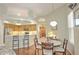 View of the dining room and kitchen, with ample lighting and eat-in seating at 4532 Saddleworth Cir, Orlando, FL 32826