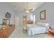 Well-lit main bedroom featuring a king bed, ensuite bathroom access, and a ceiling fan at 4532 Saddleworth Cir, Orlando, FL 32826