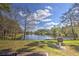 Scenic pond view surrounded by trees and lush greenery under a bright blue sky at 4532 Saddleworth Cir, Orlando, FL 32826