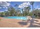 Community swimming pool with lounge chairs and well-maintained brick paver deck at 4532 Saddleworth Cir, Orlando, FL 32826