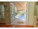 View through the doorway to the screened lanai with a refreshing pool at 4532 Saddleworth Cir, Orlando, FL 32826