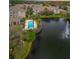 Beautiful aerial view of condo community, showcasing pool, spa, fountain pond and lush landscaping at 4865 Cypress Woods Dr # 2105, Orlando, FL 32811