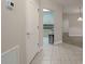 Inviting tiled hallway leading to the kitchen and living area, showcasing a seamless transition between spaces at 4865 Cypress Woods Dr # 2105, Orlando, FL 32811