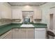 Functional kitchen with vintage wallpaper, green countertops, and a sink overlooking the living area at 4865 Cypress Woods Dr # 2105, Orlando, FL 32811