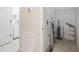 Small storage area with storage ladder, shelving, and a view of the laundry room at 4865 Cypress Woods Dr # 2105, Orlando, FL 32811