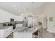 Bright kitchen featuring white cabinetry, stainless appliances, and an oversized granite island with seating at 5021 Sweet Leaf Ct, Altamonte Springs, FL 32714