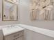 Elegant half bathroom featuring a modern vanity, stylish mirror, decorative accents and soft neutral colors at 5021 Sweet Leaf Ct, Altamonte Springs, FL 32714