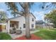 Back exterior of the home featuring a covered patio, brick paver patio, and a large backyard at 5021 Sweet Leaf Ct, Altamonte Springs, FL 32714