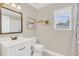 Bright bathroom featuring a vanity sink, toilet, and a natural light from a window at 5021 Sweet Leaf Ct, Altamonte Springs, FL 32714