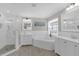 Bright bathroom features double sinks, a soaking tub, and a glass-enclosed shower with decorative tile flooring at 5021 Sweet Leaf Ct, Altamonte Springs, FL 32714