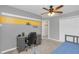 Comfortable bedroom with a striped accent wall, ceiling fan, and neutral decor at 5021 Sweet Leaf Ct, Altamonte Springs, FL 32714