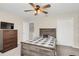 Comfortable bedroom with a rustic bed frame, neutral tones, and ample storage space at 5021 Sweet Leaf Ct, Altamonte Springs, FL 32714