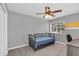 Cozy bedroom featuring grey walls with yellow accents, a ceiling fan, and comfortable furniture at 5021 Sweet Leaf Ct, Altamonte Springs, FL 32714