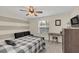 Cozy bedroom with neutral tones, a ceiling fan, and a well-lit workspace at 5021 Sweet Leaf Ct, Altamonte Springs, FL 32714