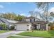 Charming two-story home with a well-manicured lawn, a two car garage, and classic architectural detailing at 5021 Sweet Leaf Ct, Altamonte Springs, FL 32714