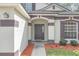 Welcoming front entrance featuring an arched entryway, decorative trim, and lush landscaping at 5021 Sweet Leaf Ct, Altamonte Springs, FL 32714