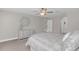 A serene main bedroom featuring neutral tones, a ceiling fan, and an elegant decorative wall piece at 5021 Sweet Leaf Ct, Altamonte Springs, FL 32714