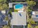 An aerial view of the house and swimming pool surrounded by mature trees and landscaping at 5073 Lake Howell Rd, Winter Park, FL 32792