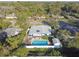 Aerial view of a home featuring a pool, fenced backyard, and screened-in porch at 5073 Lake Howell Rd, Winter Park, FL 32792