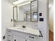 Bathroom with a white vanity, an elegant mirror, and wall sconces at 5073 Lake Howell Rd, Winter Park, FL 32792