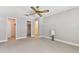 Neutral-colored bedroom with three doorways, neutral carpet, gray walls, and a large window at 5073 Lake Howell Rd, Winter Park, FL 32792