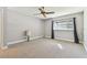 Bedroom featuring neutral carpet, gray walls, and a large window at 5073 Lake Howell Rd, Winter Park, FL 32792