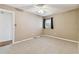 Carpeted bedroom featuring a ceiling fan, neutral walls, and a window at 5073 Lake Howell Rd, Winter Park, FL 32792