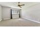 A bright bedroom featuring neutral carpet, gray walls, and a large window at 5073 Lake Howell Rd, Winter Park, FL 32792