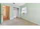 Bedroom features a closet, neutral carpet, and light green walls at 5073 Lake Howell Rd, Winter Park, FL 32792