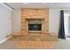 Close-up of a stone fireplace with tiled hearth and neutral-colored walls and floors at 5073 Lake Howell Rd, Winter Park, FL 32792