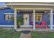 Inviting front porch area with colorful chairs, a small table and decorative plants at 5073 Lake Howell Rd, Winter Park, FL 32792