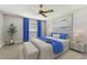 Well-lit main bedroom with a ceiling fan, large windows, and neutral wall paint at 5073 Lake Howell Rd, Winter Park, FL 32792