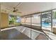 Enclosed patio with ceiling fan and view of pool at 5073 Lake Howell Rd, Winter Park, FL 32792