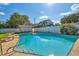 A clear blue in-ground pool with ladder and surrounding patio with a white privacy fence at 5073 Lake Howell Rd, Winter Park, FL 32792