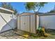 Exterior shot of a shed in the backyard with white fencing at 5073 Lake Howell Rd, Winter Park, FL 32792