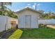 Exterior shot of a white storage shed in the backyard at 5073 Lake Howell Rd, Winter Park, FL 32792