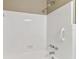 All-white tiled shower with grab bar and updated showerhead at 5073 Lake Howell Rd, Winter Park, FL 32792