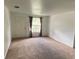 Bright living room featuring neutral walls, carpet flooring, and a window with curtains at 510 Lavon Dr, Altamonte Springs, FL 32701