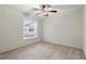 Neutral bedroom with natural light from window, plush carpet and ceiling fan at 5849 Groveline Dr, Orlando, FL 32810