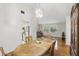 Bright dining area with wood floors, chandelier, and a view to both the kitchen and living room at 5849 Groveline Dr, Orlando, FL 32810