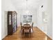 Traditional dining room features wood floors, chandelier, china cabinet, and a view to the backyard at 5849 Groveline Dr, Orlando, FL 32810