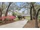 Charming single-story home with brick facade, green garage door, and mature landscaping at 5849 Groveline Dr, Orlando, FL 32810