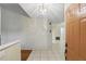 Bright foyer featuring tile flooring and a modern light fixture at 5849 Groveline Dr, Orlando, FL 32810