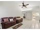 Inviting living room features tile floors, vaulted ceiling and flows into the kitchen, perfect for gatherings at 5849 Groveline Dr, Orlando, FL 32810